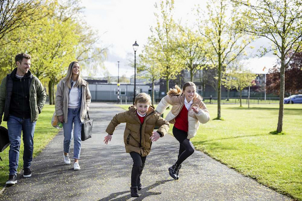 Two Children running away from two adults